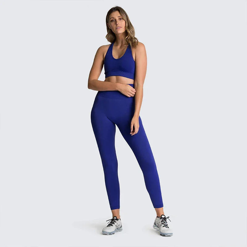 Woman in blue seamless workout leggings and sports bra set on light gray background