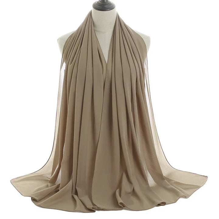 Beige pleated chiffon scarf displayed on a mannequin against white background