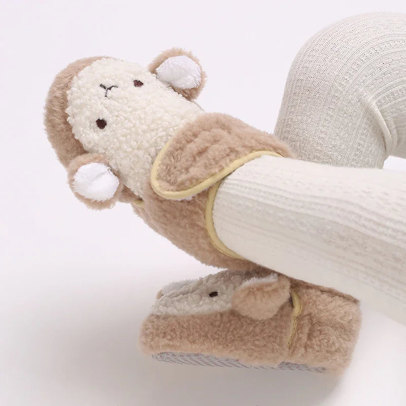 Cute beige and white sheep slippers worn with white ribbed tights on a light background
