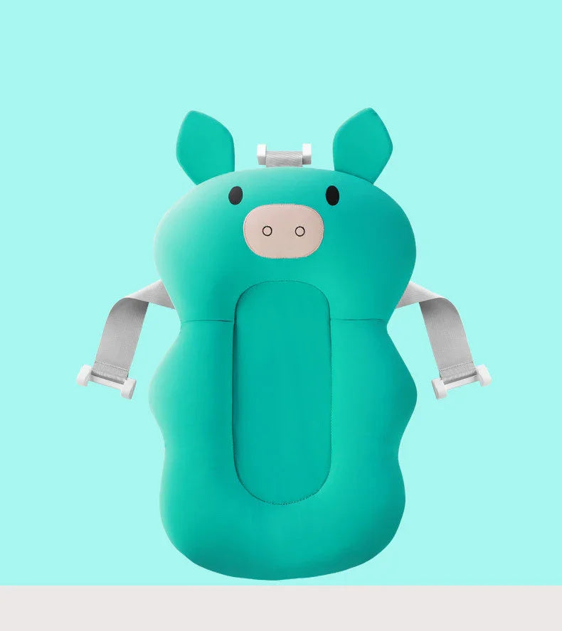 Teal baby bath support cushion shaped like a pig with adjustable gray straps on turquoise background