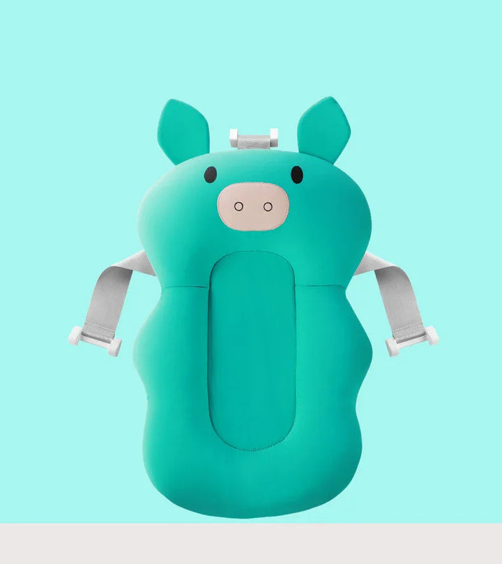 Teal baby bath support cushion shaped like a pig with adjustable gray straps on turquoise background