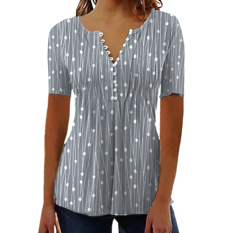 Woman wearing a gray short-sleeve blouse with white dotted and striped pattern and buttons