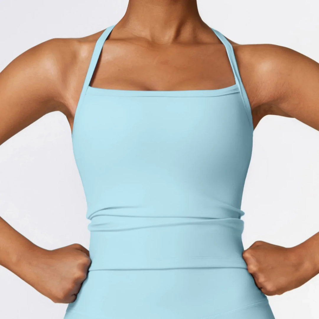 Woman wearing light blue square-neck athletic tank top with slim straps and fitted waist