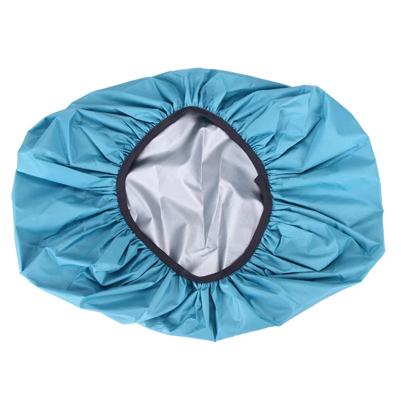 Blue waterproof shower cap with elastic edge on white background
