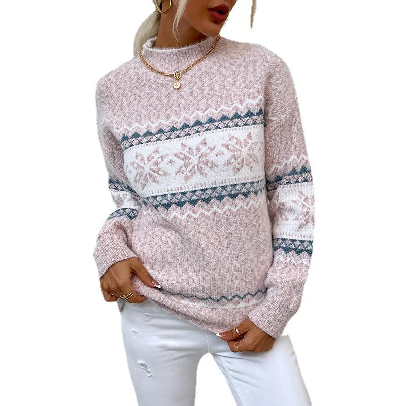 Woman wearing pink and white Nordic pattern knit sweater with gold jewelry and white pants