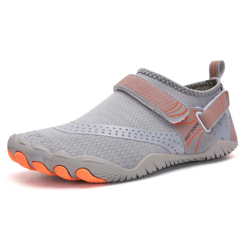 Light grey outdoor water shoe with orange accents, adjustable strap, and textured sole for grip