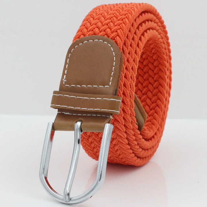 Orange woven belt with brown leather buckle and silver metal prong on white background