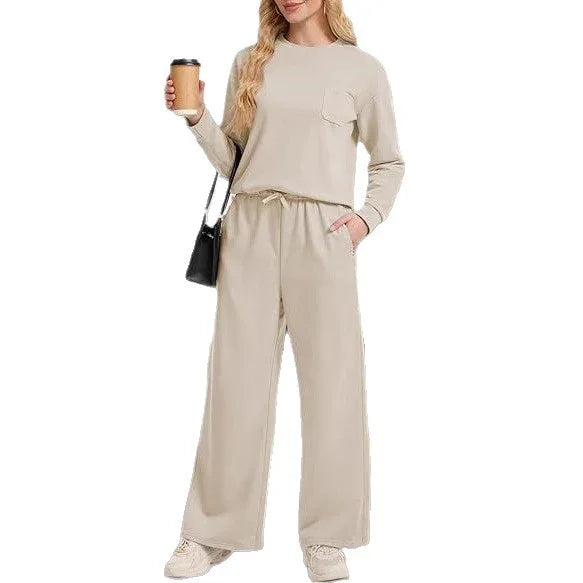 Woman wearing beige casual loungewear set with long sleeves and wide-leg pants, holding coffee cup and black shoulder bag