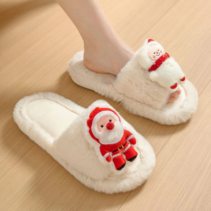 Cozy cream-colored Christmas slippers with plush Santa and snowman decorations on wood floor