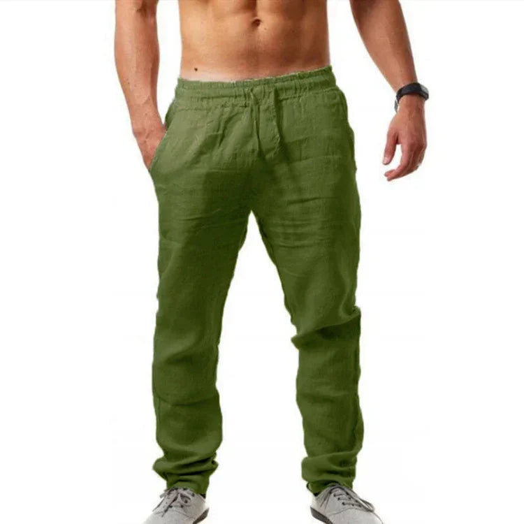 Man wearing olive green casual jogger pants with elastic waistband and pockets, paired with gray sneakers