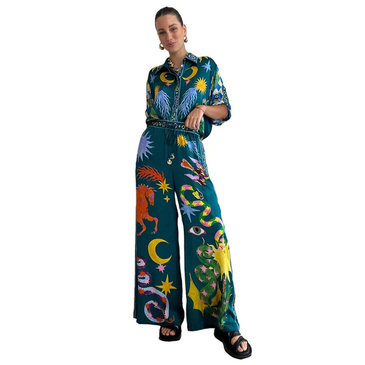 Woman wearing vibrant celestial print shirt and wide-leg pants with stars, moon, and sun patterns