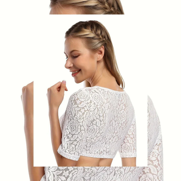 Smiling woman with braided hair wearing a white floral lace cropped top against white background