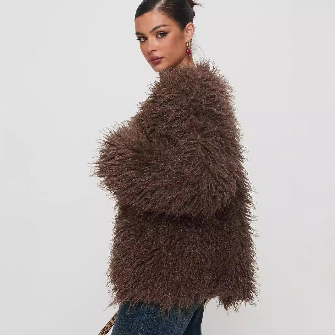 woman in dark brown fluffy faux fur jacket posing against plain white background