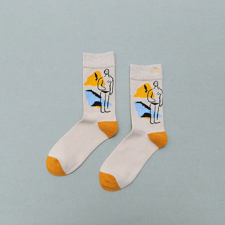 Beige socks with orange toes and heels featuring abstract art design of a standing figure and colorful shapes