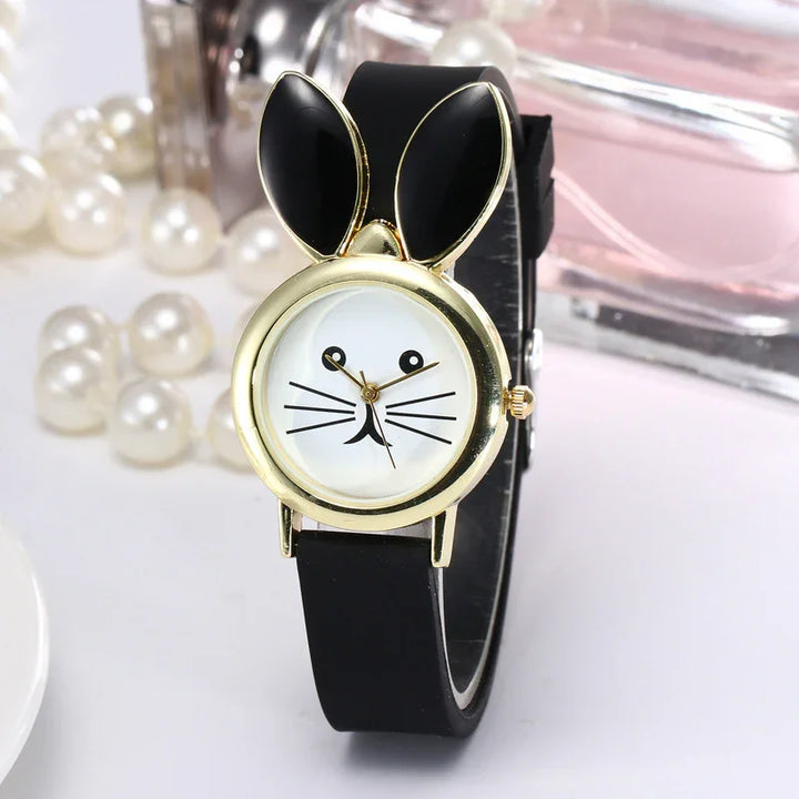 Cute black wristwatch with gold bunny ears and a white face featuring a simple cat whiskers design