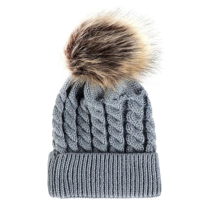 Gray knitted beanie hat with cable pattern and large brown faux fur pom pom