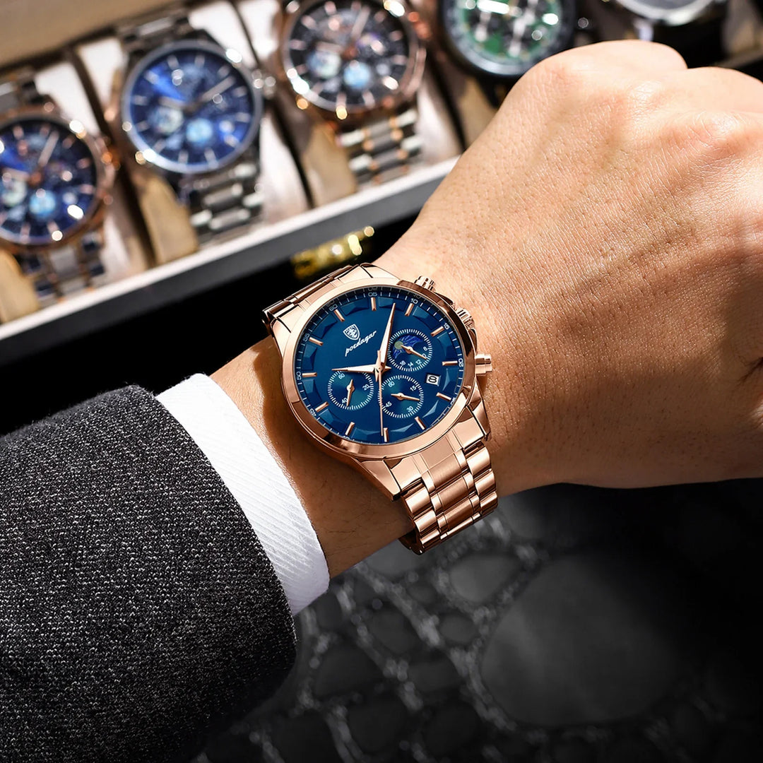 Rose gold wristwatch with blue dial and chronograph on man's wrist in formal suit