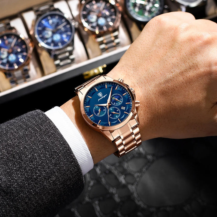 Rose gold wristwatch with blue dial and chronograph on man's wrist in formal suit