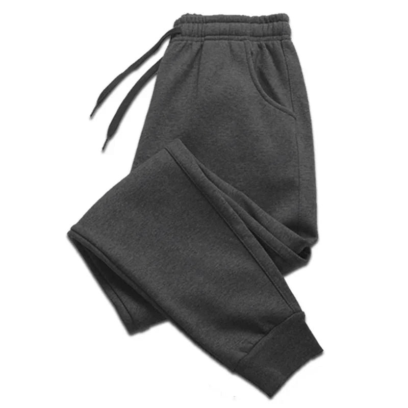 Dark gray men's jogger pants with drawstring waist and cuffed ankles on white background