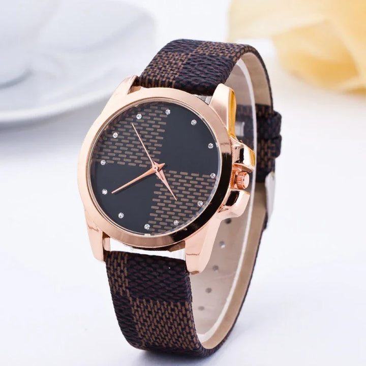 Elegant wristwatch with rose gold case, black patterned dial, and brown textured strap