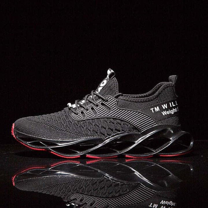 Black athletic sneaker with mesh upper and intricate sole design on reflective surface