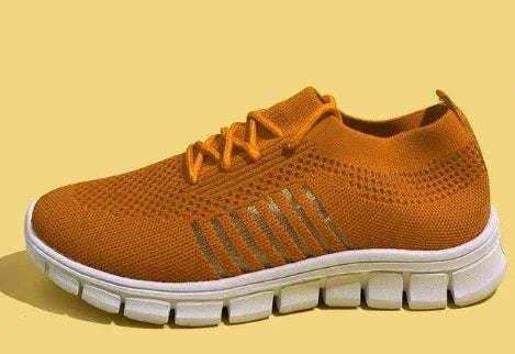 Orange knitted lightweight running shoe with white segmented sole on yellow background