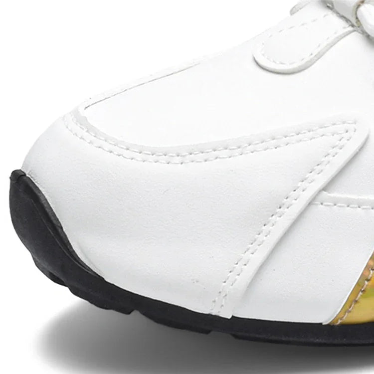 Close-up of white leather sneaker toe with black rubber sole and detailed stitching