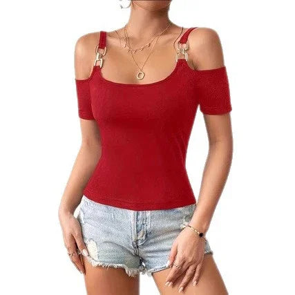 Woman wearing stylish red off-shoulder top with gold buckle straps paired with light blue denim shorts