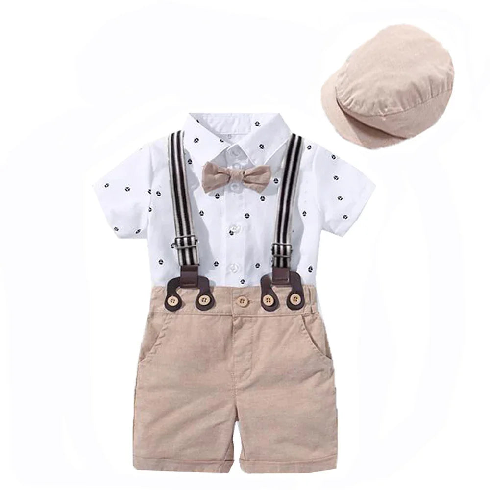 Toddler boys' summer outfit with white patterned shirt, beige shorts with suspenders, bow tie, and matching cap