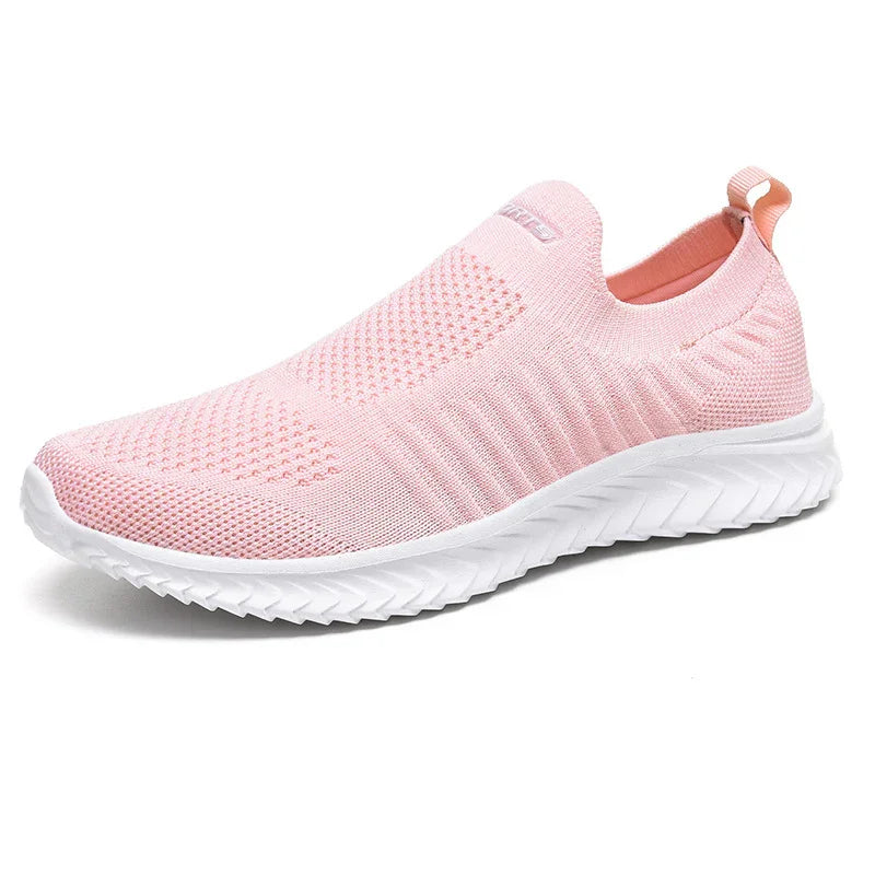 Light pink slip-on knit sneaker with white textured sole and pull tab on heel