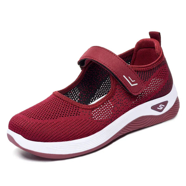 Women's breathable red Mary Jane sneaker with adjustable strap and cushioned white sole