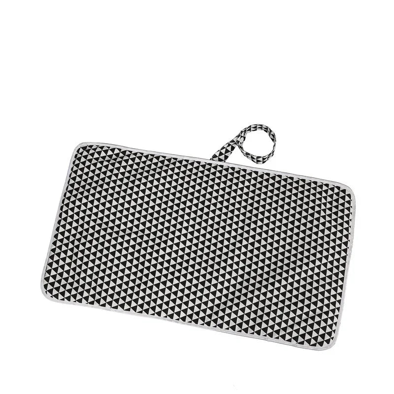 Black and white geometric patterned portable picnic blanket with carrying strap