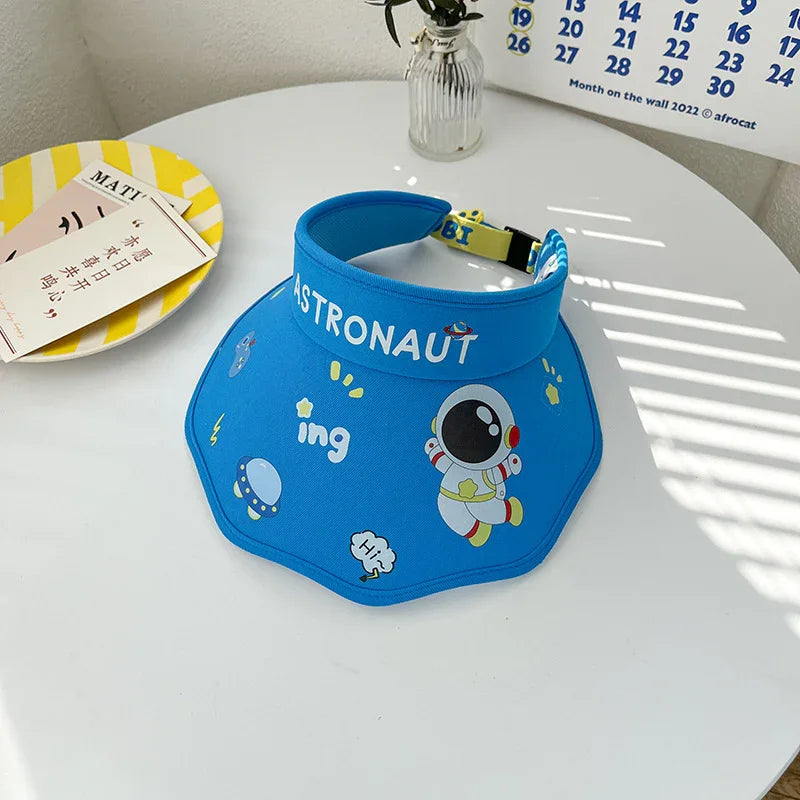 Blue astronaut-themed sun visor with cartoon space designs on white round table