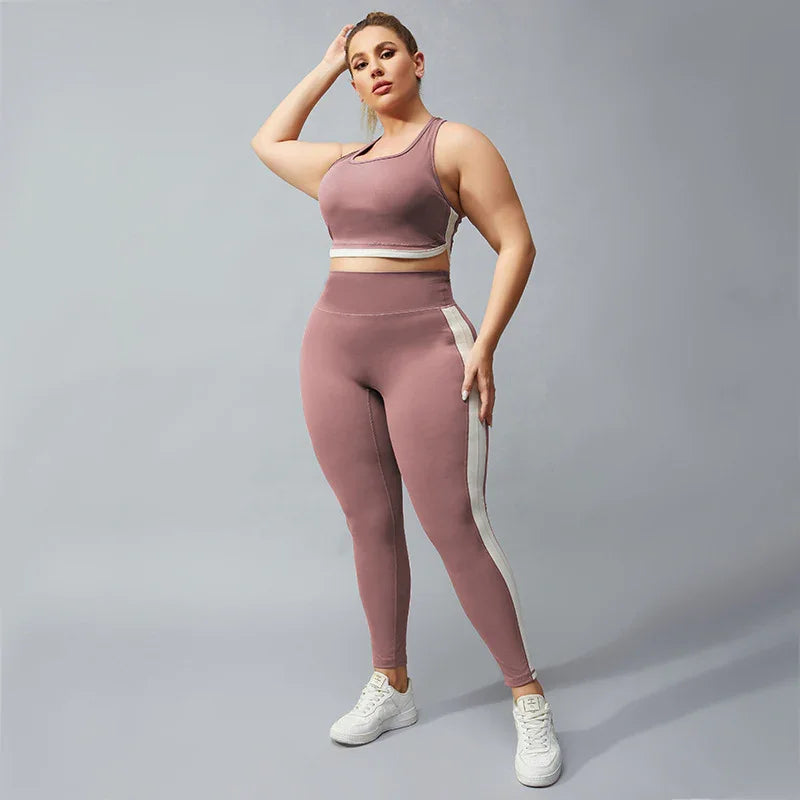 Plus size woman wearing mauve sports bra and leggings with white stripe, white sneakers, gray background