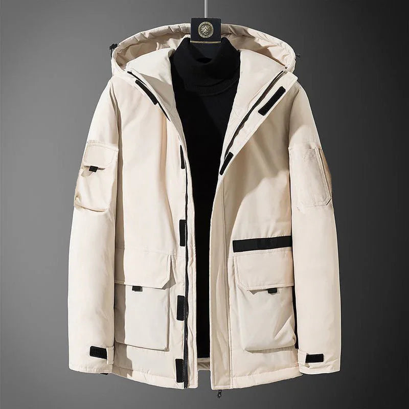 Beige men's winter hooded jacket with black zipper and pockets on gray background