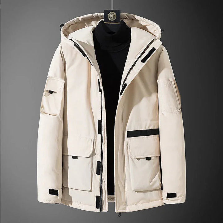 Beige men's winter hooded jacket with black zipper and pockets on gray background