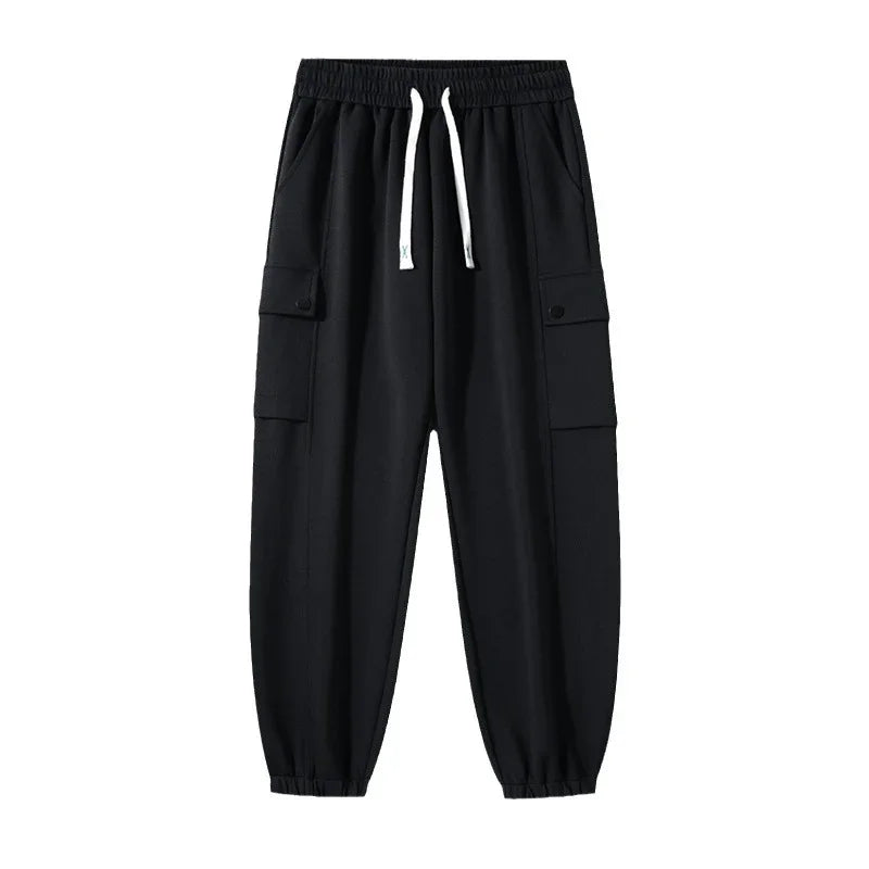 Black cargo jogger pants with elastic waistband and white drawstrings isolated on white