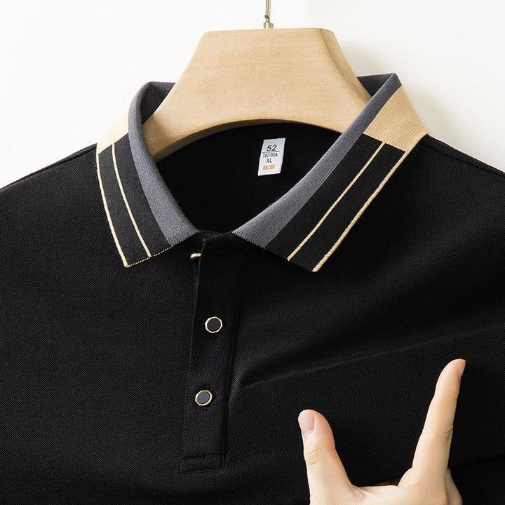 Black polo shirt with contrasting striped collar in beige and gray, displayed on wooden hanger