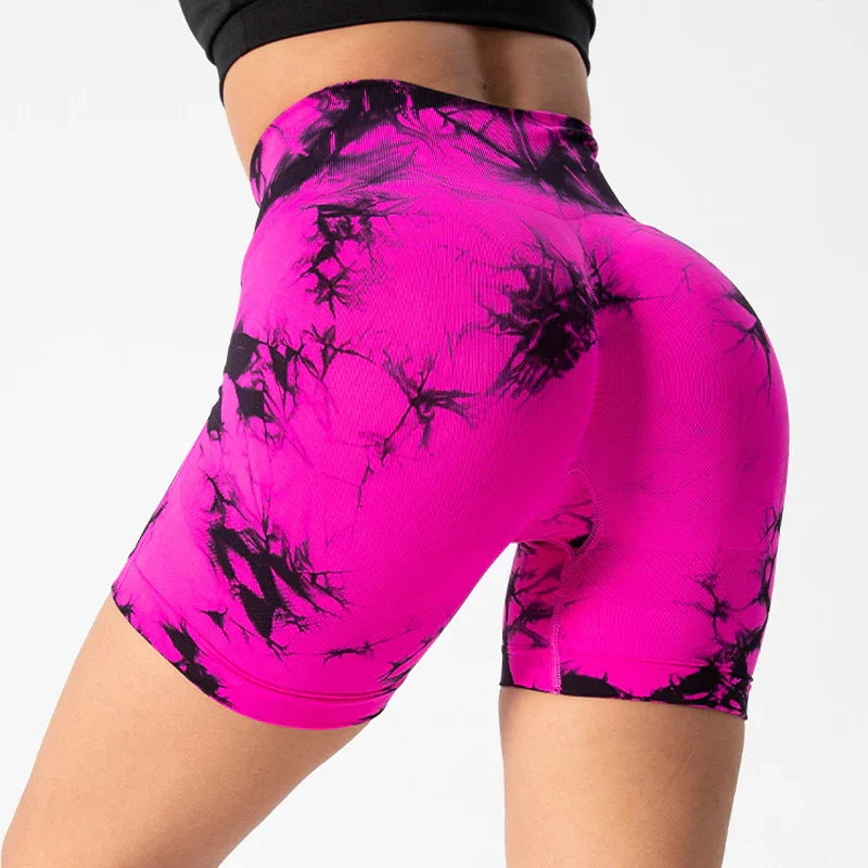Close-up of bright pink and black tie-dye high-waisted biker shorts on a fit model