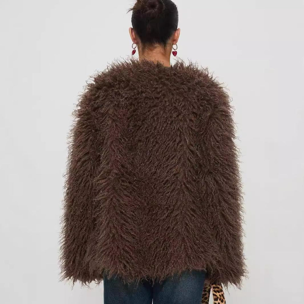 Rear view of woman wearing a dark brown shaggy faux fur jacket with blue jeans and red heart earrings