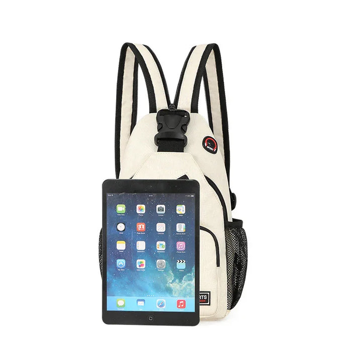 beige sling backpack with black trim and side mesh pocket holding a tablet