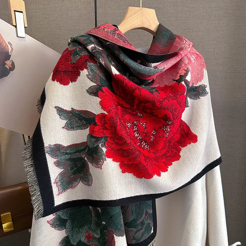 Elegant white scarf with large red floral print and green leaves on wooden hanger