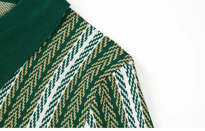 Close-up of green, white, and yellow knit sweater fabric with zigzag pattern and green collar