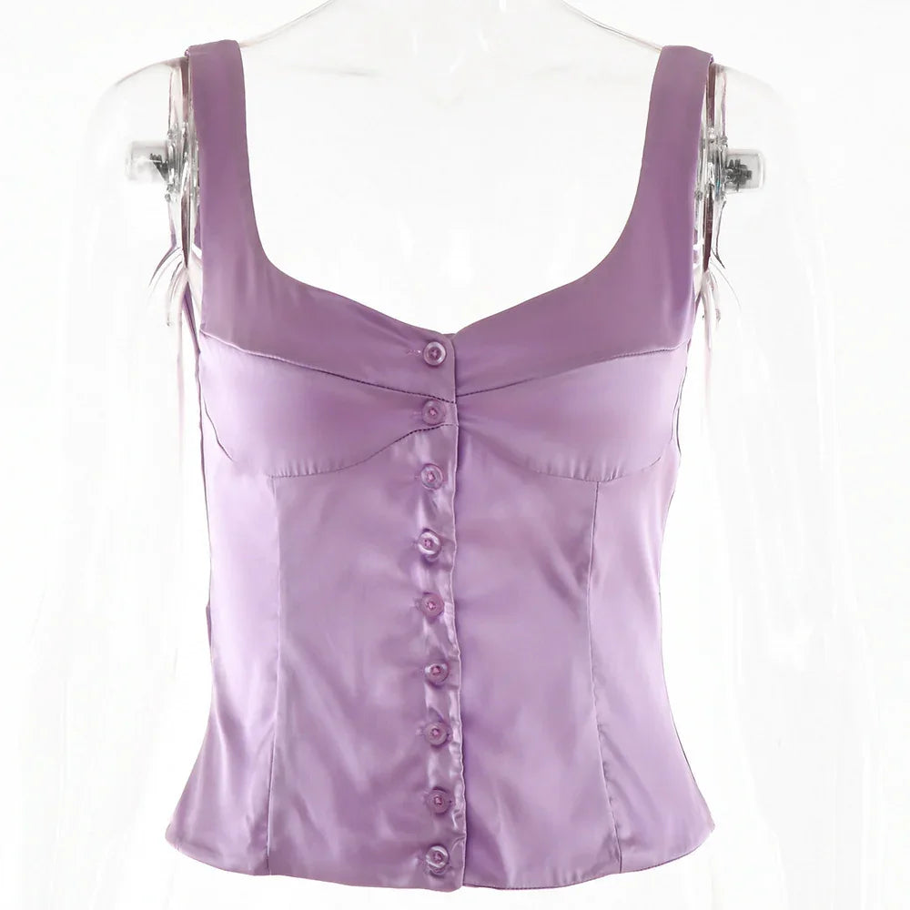 Elegant lavender satin sleeveless button-up top with wide straps on clear mannequin