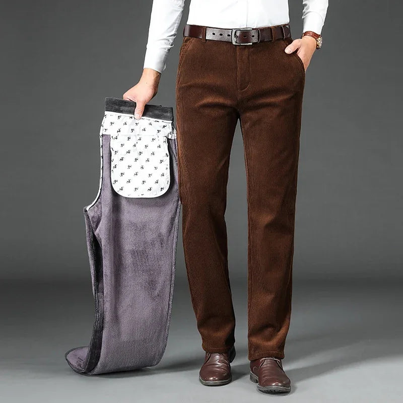 Man wearing brown corduroy pants holding gray fleece-lined pants with white patterned inner lining