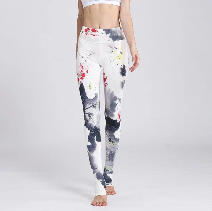 Woman wearing high-waist white leggings with abstract black, red, and yellow paint splatter design