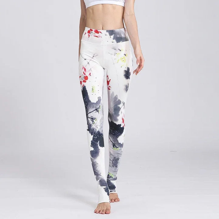 Woman wearing high-waist white leggings with abstract black, red, and yellow paint splatter design