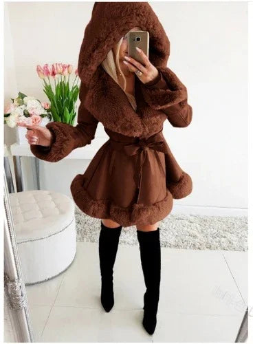 woman wearing brown faux fur hooded coat with bow belt and black knee-high boots indoors