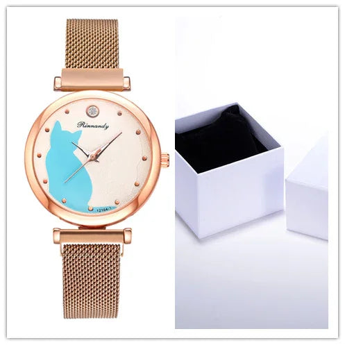 Rose gold wristwatch with mesh band and blue cat silhouette on white dial, alongside open white jewelry box