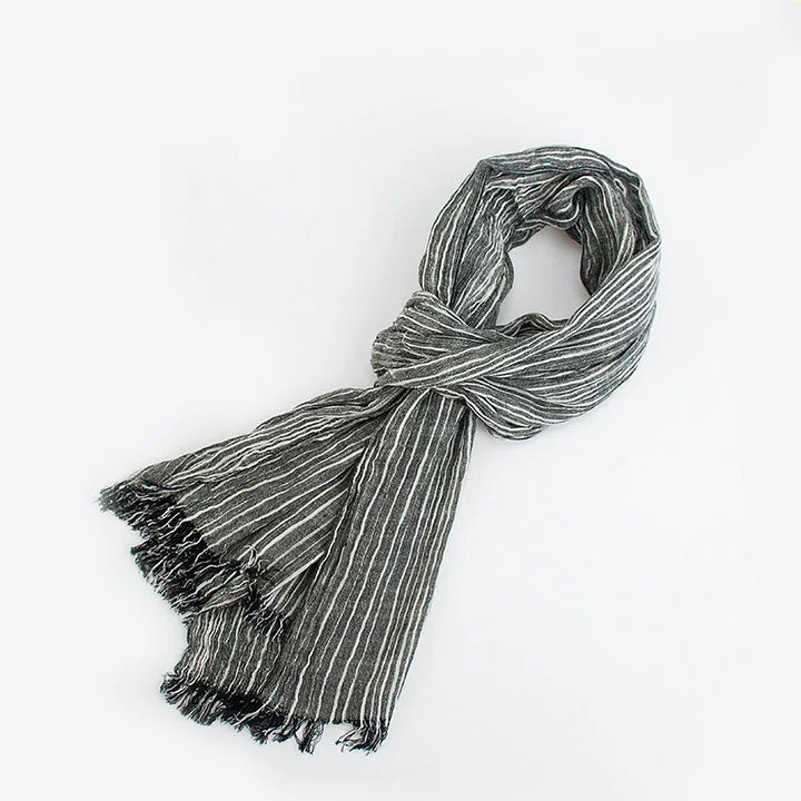 Black and white striped lightweight scarf with fringed edges on white background